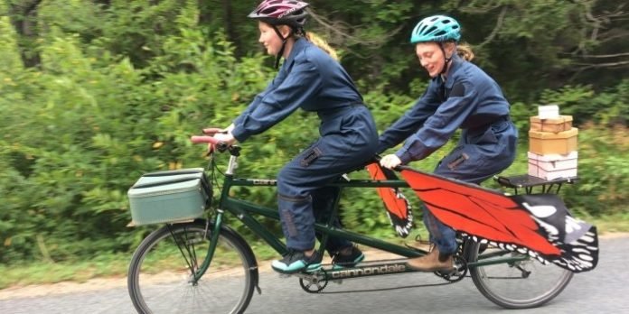 Lily Falk and Franziska Glen perform in A Tale on Two Wheels, a free performance for kids and families delivered by tandem bicycle to local parks.