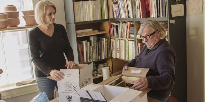 Jane helps artist Doug Bamford sort through his book collection in preparation for his move from a 3000-square-foot Victorian house to an apartment.